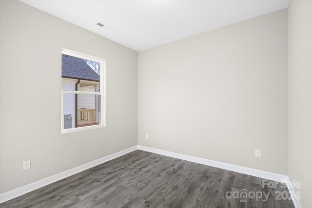 spare room with dark hardwood / wood-style floors