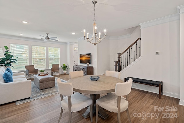 dining area with crown molding, hardwood / wood-style floors, and ceiling fan with notable chandelier