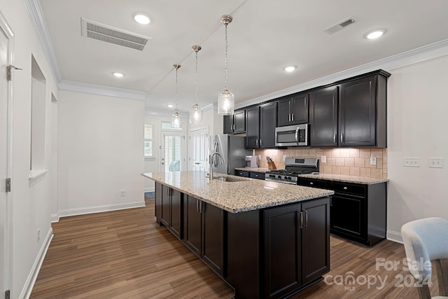 208 Waterlynn Ridge Rd Unit B, Mooresville, NC 28117 - kitchen featuring appliances with stainless steel finishes, a sink, wood finished floors, backsplash, and crown molding