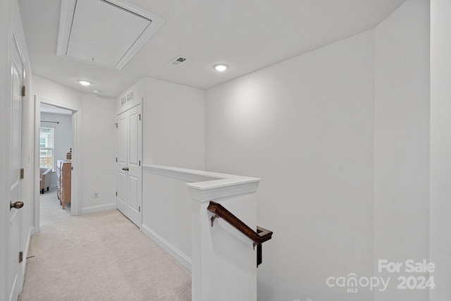 hallway with light colored carpet