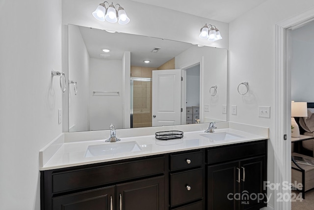 bathroom with a shower with door and vanity