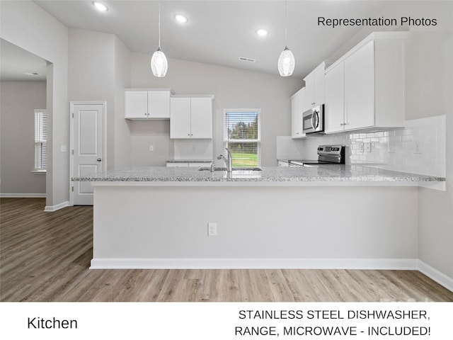 204 Lake George Dr, Shelby, NC 28152 - kitchen with stainless steel appliances, lofted ceiling, white cabinets, wood finished floors, and tasteful backsplash