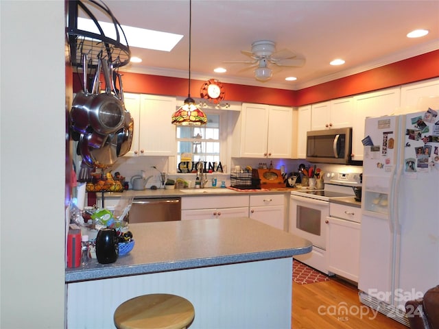 kitchen featuring pendant lighting, light hardwood / wood-style flooring, ceiling fan, white cabinetry, and stainless steel appliances