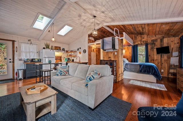 living room with vaulted ceiling with skylight, wood ceiling, dark hardwood / wood-style floors, and sink