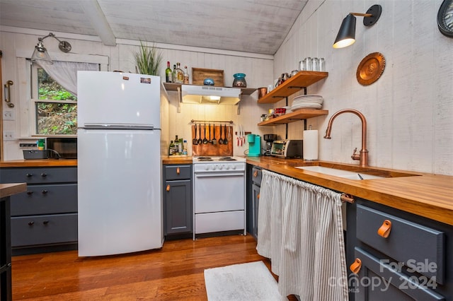 kitchen with white appliances, butcher block countertops, dark hardwood / wood-style floors, and gray cabinetry