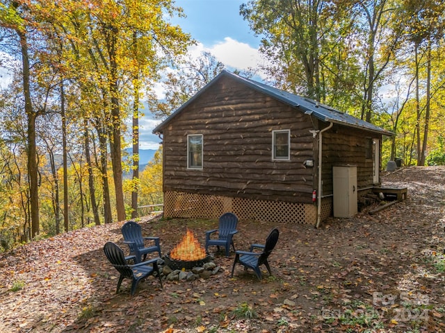 view of property exterior featuring a fire pit