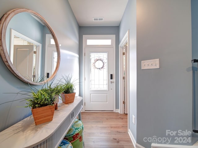 doorway to outside with light wood-type flooring