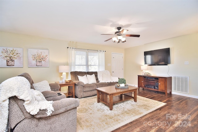 living room with ceiling fan and dark hardwood / wood-style flooring