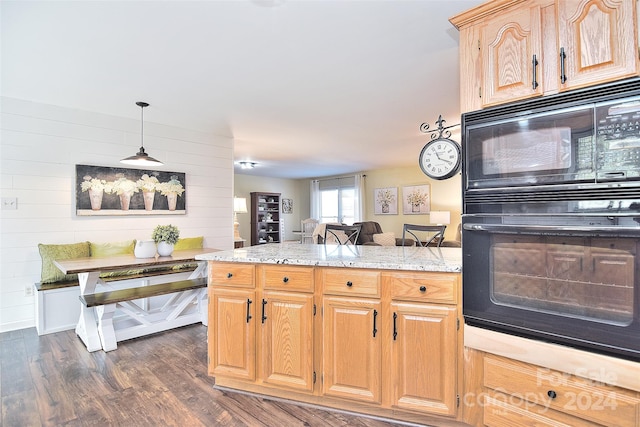 kitchen with black appliances, pendant lighting, dark hardwood / wood-style flooring, and light stone countertops