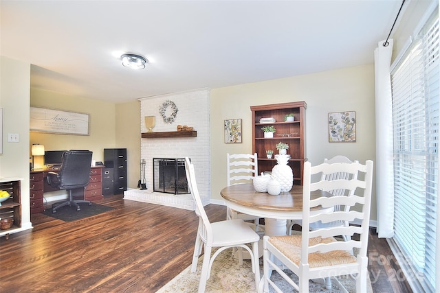 dining space featuring dark hardwood / wood-style flooring, plenty of natural light, and a fireplace