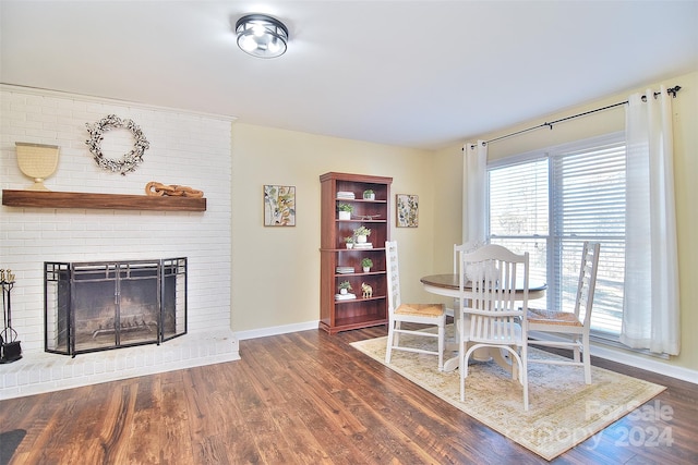 dining room featuring a fireplace and dark wood-type flooring