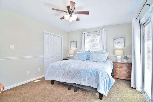 bedroom featuring ceiling fan, light colored carpet, and a closet