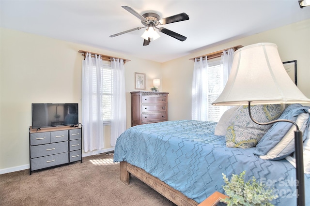 bedroom featuring carpet, multiple windows, and ceiling fan