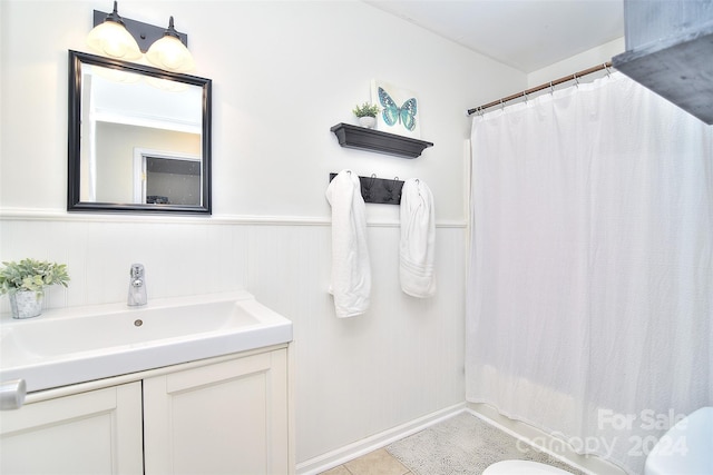 bathroom featuring tile patterned flooring, vanity, and walk in shower