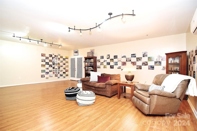 living room featuring light wood-type flooring and rail lighting