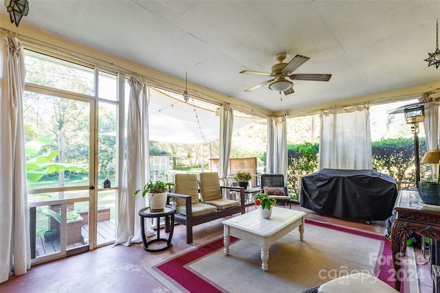 sunroom featuring ceiling fan