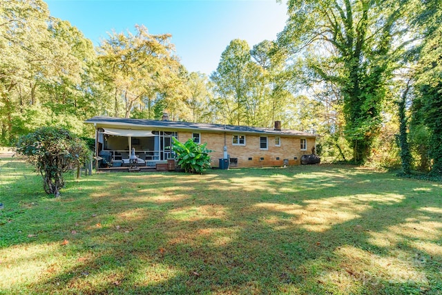 back of property featuring a lawn