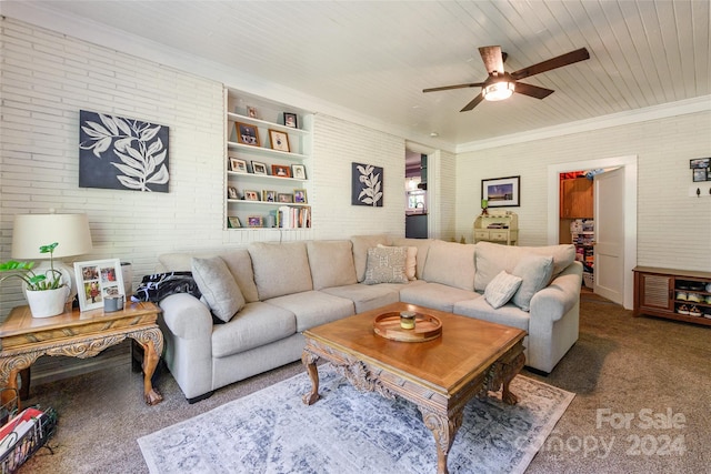 carpeted living room with ornamental molding, ceiling fan, wooden ceiling, and brick wall