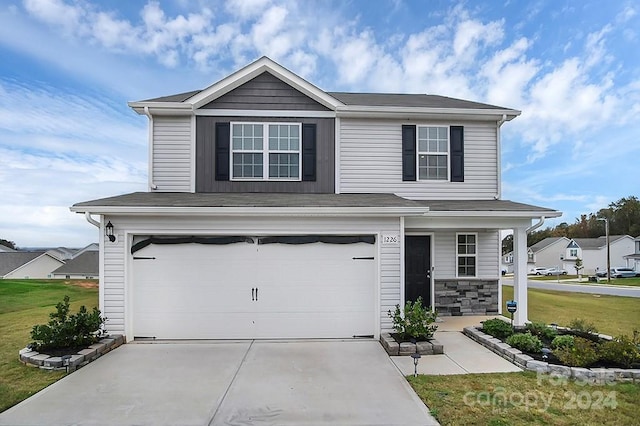 view of front property featuring a garage and a front yard