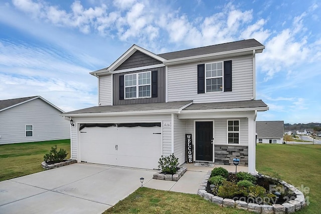 view of front of property featuring a garage and a front lawn