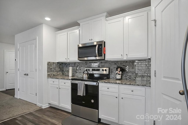 kitchen with stainless steel appliances, backsplash, dark hardwood / wood-style floors, white cabinets, and dark stone countertops