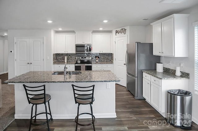 kitchen featuring dark wood-type flooring, white cabinetry, sink, and stainless steel appliances