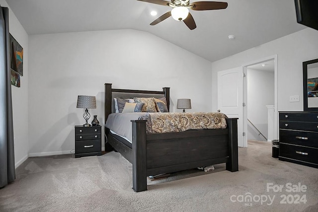 bedroom with ceiling fan, lofted ceiling, and light colored carpet