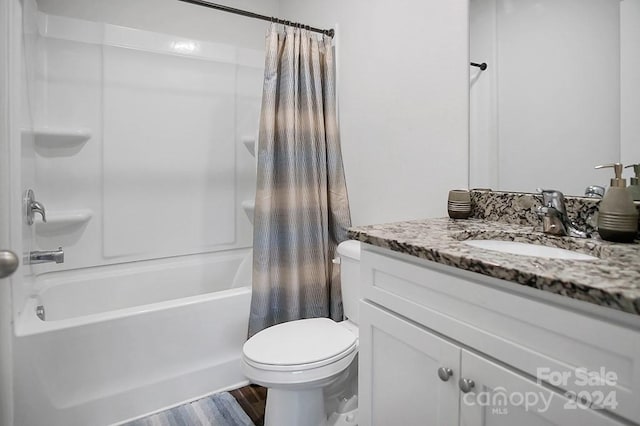 full bathroom with hardwood / wood-style flooring, shower / tub combo with curtain, vanity, and toilet