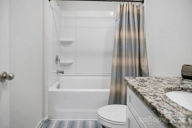 full bathroom featuring toilet, vanity, wood-type flooring, and shower / bathtub combination with curtain