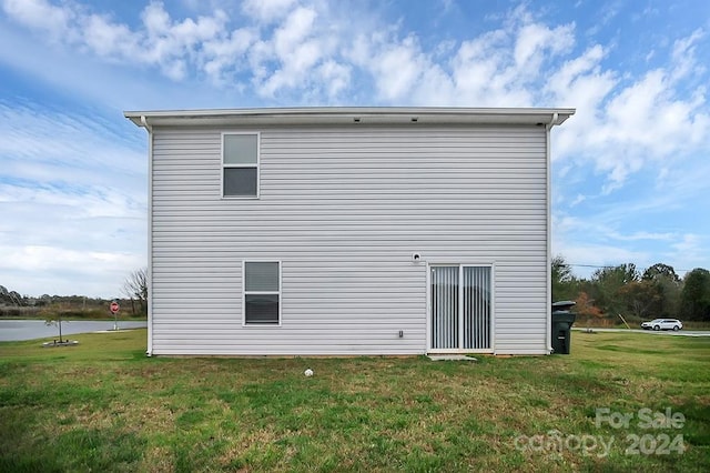 rear view of house with a yard