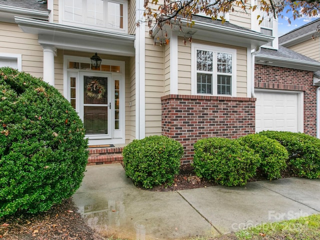 doorway to property featuring a garage