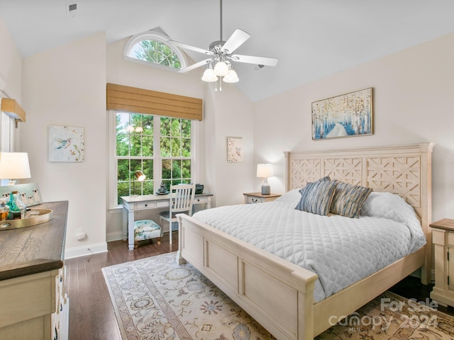 bedroom featuring dark hardwood / wood-style floors, ceiling fan, lofted ceiling, and multiple windows