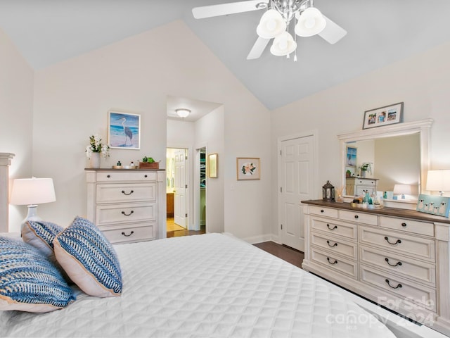 bedroom featuring hardwood / wood-style floors, ensuite bathroom, ceiling fan, and vaulted ceiling