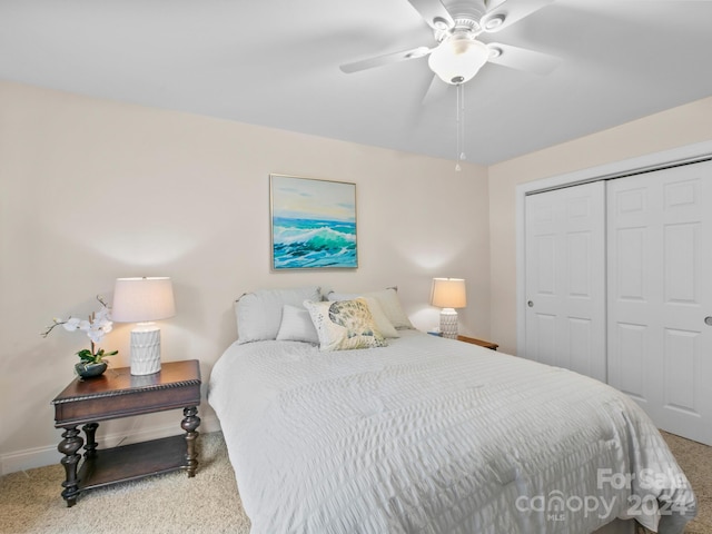 bedroom with ceiling fan, carpet floors, and a closet