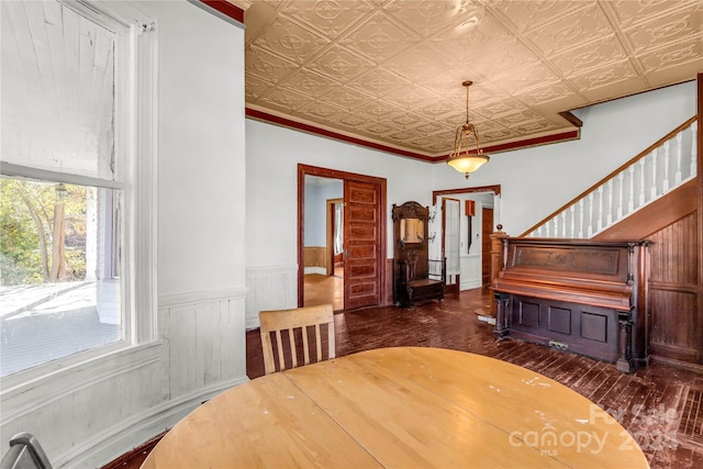 dining area featuring dark hardwood / wood-style floors and crown molding