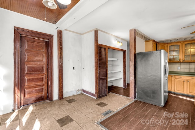 kitchen with decorative backsplash, stainless steel fridge with ice dispenser, ceiling fan, and wood-type flooring