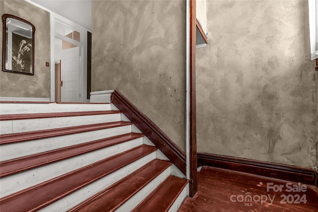 stairs featuring hardwood / wood-style flooring