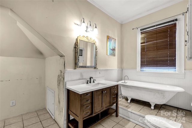 bathroom with a tub, tile patterned flooring, vanity, and ornamental molding