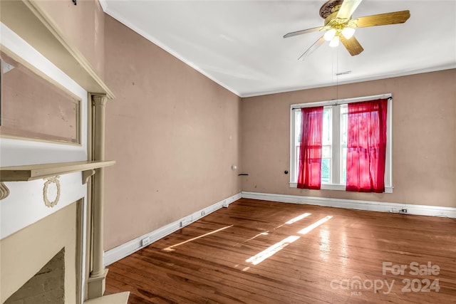 unfurnished room featuring ornate columns, ceiling fan, and hardwood / wood-style floors