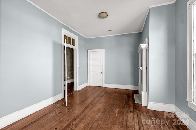 unfurnished bedroom featuring dark hardwood / wood-style flooring and ornamental molding