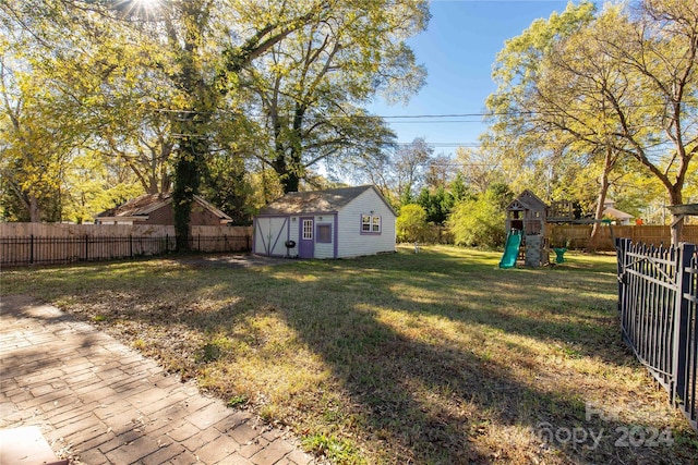 view of yard with a playground and a shed