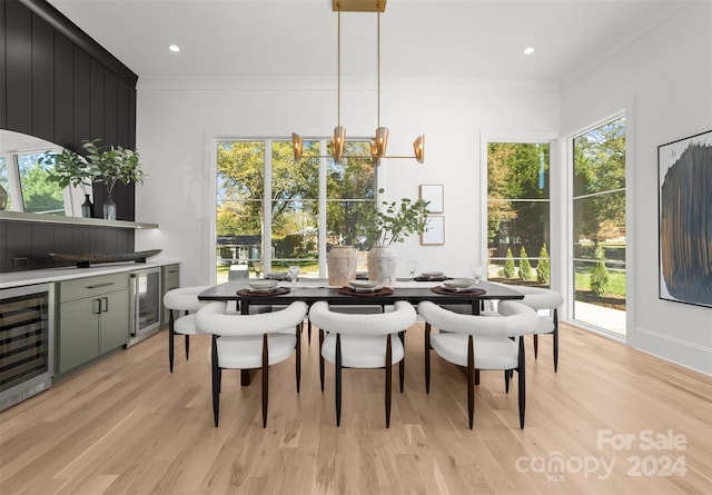 dining area featuring plenty of natural light, beverage cooler, and light wood-type flooring