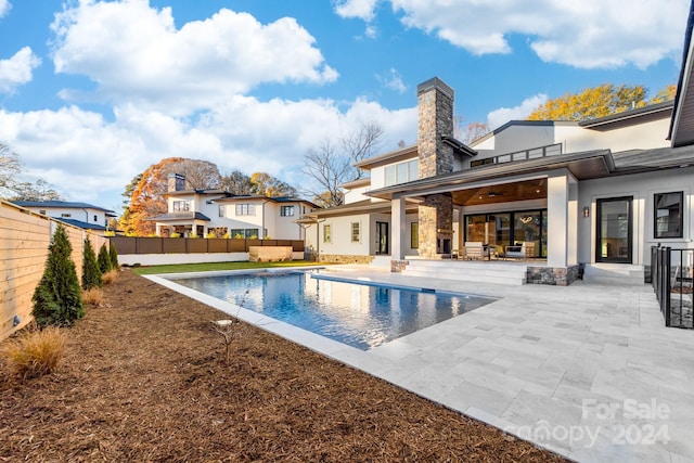 view of pool with ceiling fan and a patio area