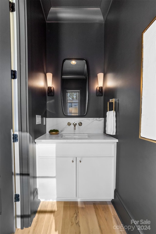 bathroom with hardwood / wood-style floors and vanity