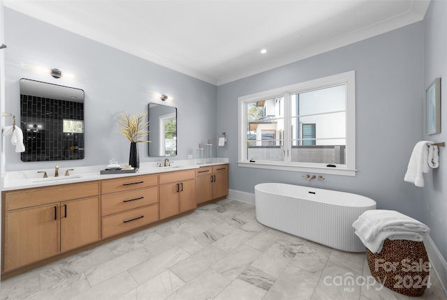 bathroom with a washtub, crown molding, and vanity