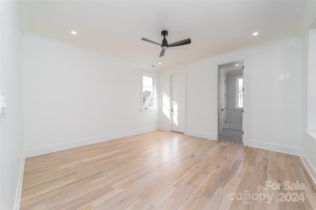 spare room featuring ceiling fan, light hardwood / wood-style flooring, and ornamental molding