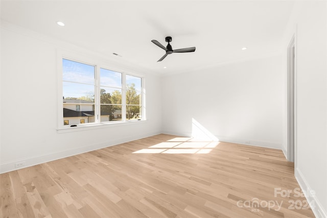 spare room with ceiling fan and light hardwood / wood-style flooring