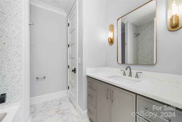 bathroom with tiled shower and vanity