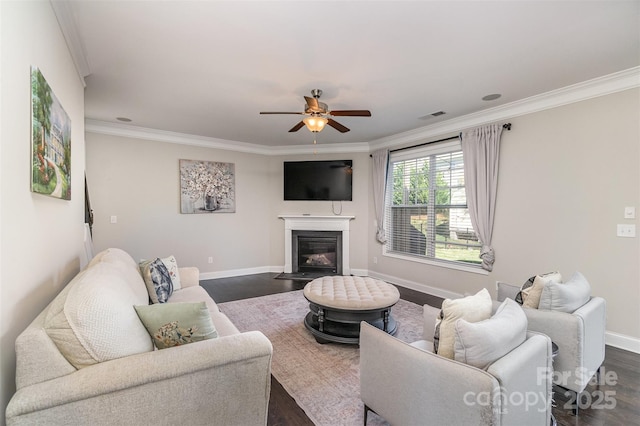 living room with crown molding, dark hardwood / wood-style flooring, and ceiling fan