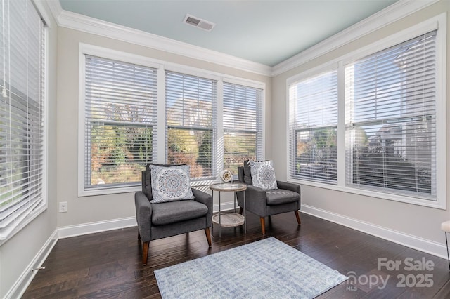 living area with dark hardwood / wood-style floors, plenty of natural light, and ornamental molding